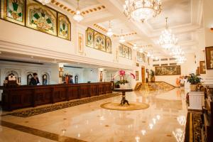 a large building with a lobby with a reception desk at Hotel Majestic Saigon in Ho Chi Minh City