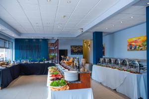 bufet z talerzami w restauracji w obiekcie Hotel des Mille Collines w mieście Kigali