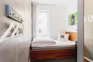 a small bedroom with a bed and a window at Smarthotel Tromsø in Tromsø