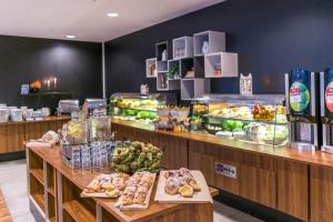 a bakery with a bunch of food on display at Smarthotel Tromsø in Tromsø