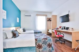 Tempat tidur dalam kamar di Comfort Hotel Joinville