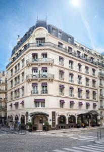 a large white building with a clock on it at Hôtel Château Frontenac in Paris