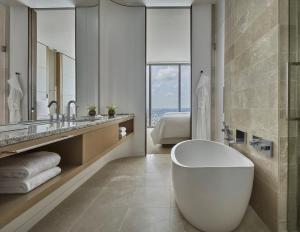 a bathroom with a large white tub and a sink at Four Seasons Hotel Philadelphia at Comcast Center in Philadelphia