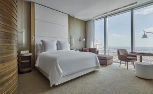 a bedroom with a large white bed and a large window at Four Seasons Hotel Philadelphia at Comcast Center in Philadelphia