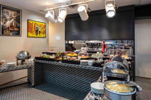 a buffet line of food in a restaurant at Le 123 Sébastopol - Astotel in Paris