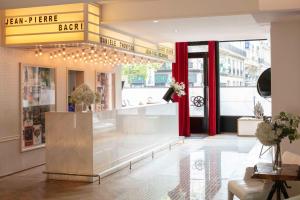 a lobby of a store with a counter and a window at Le 123 Sébastopol - Astotel in Paris