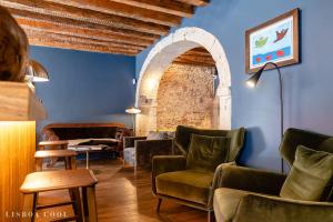 a living room with a couch and chairs and an archway at Dare Lisbon House in Lisbon