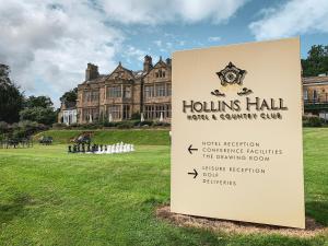 a sign in front of a large building at Hollins Hall Hotel, Golf & Country Club in Bradford