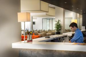 a man standing at a counter in a restaurant at Holiday Inn Express Strasbourg Centre, an IHG Hotel in Strasbourg