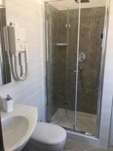 a bathroom with a shower and a toilet and a sink at Piccolo Hotel Lamezia in SantʼEufemia Lamezia