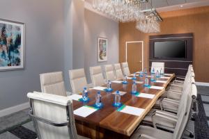 a conference room with a long wooden table and chairs at Hotel Indigo Gainesville-Celebration Pointe, an IHG Hotel in Gainesville