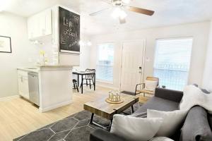 a living room with a couch and a table at The Alcove Dallas Near Downtown Fun Nightlife in Dallas