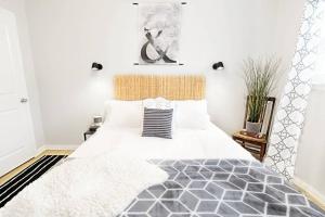 a bedroom with a large bed with white walls at The Alcove Dallas Near Downtown Fun Nightlife in Dallas