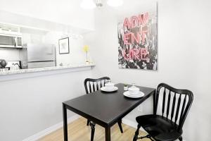 a black table and two chairs in a kitchen at The Alcove Dallas Near Downtown Fun Nightlife in Dallas