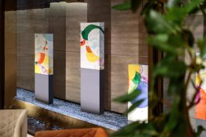 a row of colorful signs on a wall at Hotel Gran Ms Kyoto in Kyoto