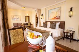 a hotel room with a bed and a bowl of fruit on a table at Sarova Whitesands Beach Resort & Spa in Mombasa