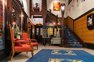 a room with a staircase with chairs and a rug at Romantik Jugendstilhotel Bellevue in Traben-Trarbach