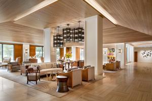 a lobby of a hotel with couches and tables at Halepuna Waikiki by Halekulani in Honolulu