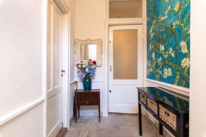 a hallway with a vase of flowers on a table at B&B Blossom in Amsterdam