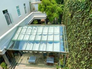 two chairs sitting on a glass walkway next to a building at Hotel Villa Condesa in Mexico City