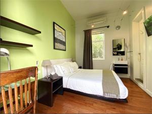 a bedroom with a white bed and a window at Hotel Villa Condesa in Mexico City