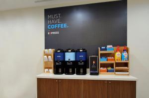 a counter with bottles of coffee on it at Holiday Inn Express & Suites - Gainesville I-75, an IHG Hotel in Gainesville