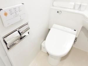 a bathroom with a white toilet in a room at APA Hotel Hiroshima Ekimae Ohashi in Hiroshima