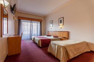 A bed or beds in a room at Residencial Horizonte