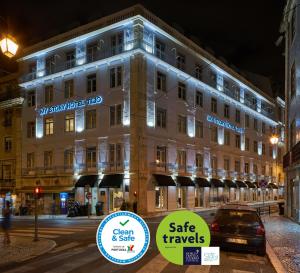 a large white building with signs in front of it at My Story Hotel Tejo in Lisbon