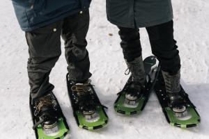 two people are standing on skis in the snow at LakeLodge Kiehinen & Igloos in Rovaniemi