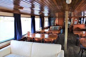 a dining car of a train with tables and chairs at AmicitiA in Amsterdam