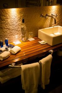 a bathroom with a sink and towels on a counter at Melia Recoleta Plaza Hotel in Buenos Aires