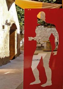 a red sign with a picture of a person and a building at Ci Thorno Hotel in Crosia