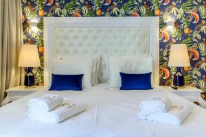 a white bed with two pillows on top of it at Villa Mariazinha Charming Hotel in Portimão