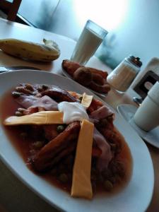 a plate of food with meat and beans on a table at Hotel Madrid in Tuxtla Gutiérrez