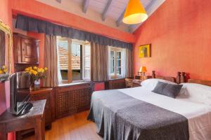 a bedroom with a large bed and a window at Hotel Pironi in Cannobio