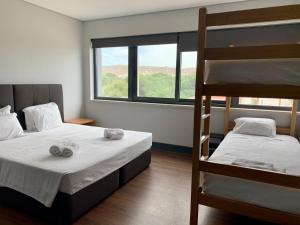 1 Schlafzimmer mit 2 Etagenbetten und einem Fenster in der Unterkunft Villa Caparica Hostel in Costa da Caparica