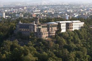 an old building on a hill with trees at Grand Fiesta Americana Chapultepec in Mexico City