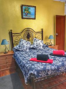 a bedroom with a bed with a blue and white comforter at Pensao Residencial Flor dos Cavaleiros in Lisbon