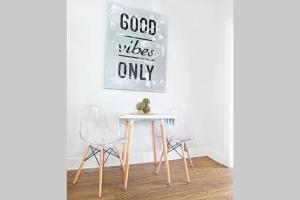 a table with two chairs and a sign that reads good vibes only at Dallas Native, Lower-Greenville Ave Area in Dallas