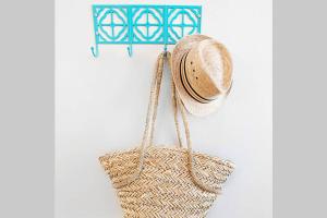 a straw hat and a basket hanging on a wall at Dallas Native, Lower-Greenville Ave Area in Dallas