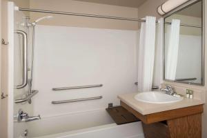 a bathroom with a sink and a shower at WoodSpring Suites Gainesville I-75 in Gainesville