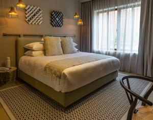 a bedroom with a large bed and a window at Agata Hotel Boutique & Spa in Mexico City