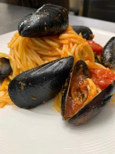 a plate of pasta with mussels and spaghetti with peppers at Hotel Continental in Reggio di Calabria