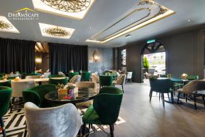 a restaurant with green chairs and tables in a room at Zetter Suites @ Cameron in Cameron Highlands