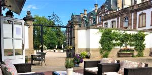 a patio with chairs and tables in front of a building at Château de Pourtalès in Strasbourg