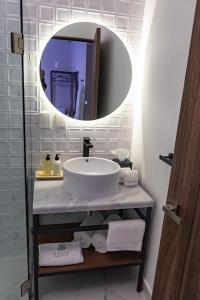 a bathroom with a sink and a mirror at Agata Hotel Boutique & Spa in Mexico City