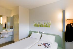 A bed or beds in a room at Ibis Budget Madrid Getafe