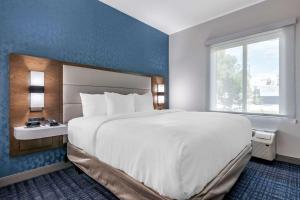 a hotel room with a large bed and a window at Comfort Suites Gainesville Near University in Gainesville