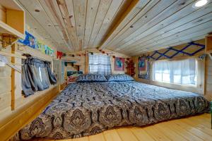 a large bed in a room with a wooden ceiling at Tiny House Leadville Colorado in Leadville